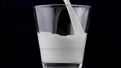 Pouring milk in a glass Stock Footage