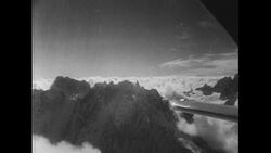 Switzerland, c.1951: Two men discuss landing plans as they fly through Mont Blanc in Switzerland Stock Footage