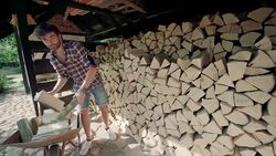 Man splitting logs for the fire Stock Footage