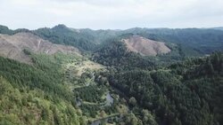 Aerial views over mountains and river in Oregon News Clip