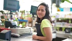 Portrait of confident owner leaning on checkout counter at flower shop Stock Footage