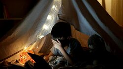 Curious kid boy secretly watching forbidden censored content on Tablet Stock Footage