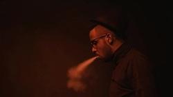 Stylish Black Man Vaping and Exhaling Smoke Stock Footage