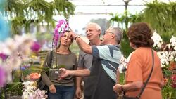 Family shop for plants with Salesman at Flower Market Stock Footage