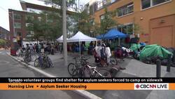 Toronto volunteers find shelter for asylum seekers forced to camp on sidewalk News Clip