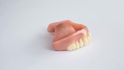 Dentures on a rotating white plate Stock Footage