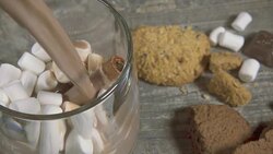 Slow motion in a transparent mug with marshmallows and cinnamon pour cocoa Stock Footage