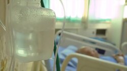 CU hospital oxygen regulator with senior patient on bed Stock Footage