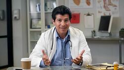 Mid adult Hispanic male doctor participates in telemedicine consultation Stock Footage