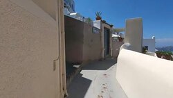 Fira, Thira overlooking the Caldera volcanic Aegean Sea with greek Orthodox cross in Santorini Greece Stock Footage