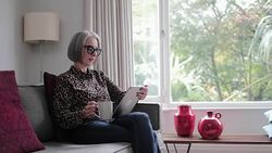 Mature adult female using a digital tablet Stock Footage