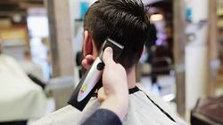 man and stylist doing haircut at barber shop Stock Footage