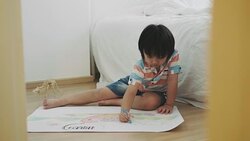 Boy is drawing and crayon of dinosaur Stock Footage