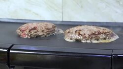 Hamburgers cooking on an electric grill Stock Footage