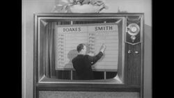 1960s: Man tallies votes on television Stock Footage