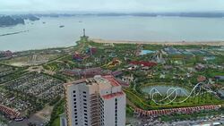 4k Aerial view over city and park with Bai Tho karst mountain Ha long bay. Halong City. Stock Footage