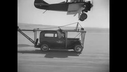 Daredevil J. D. Pate dangles from wing of plane News Clip