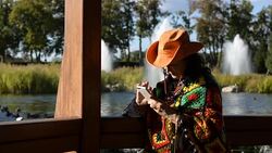 Adult stylish woman in cowboy hat and a multi colored poncho Stock Footage