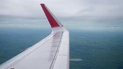 Airplane flight. Wing of an airplane flying above the clouds from window plane view Stock Footage