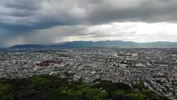 Lift pan of cloudy Kyoto cityscape Stock Footage