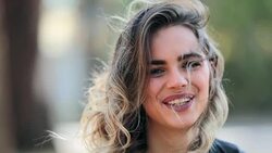 Portrait of girl spontaneous smile and lahging to camera Stock Footage