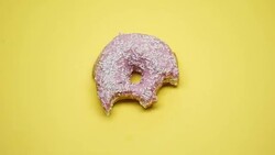 Donut biting stop motion macro, junk food and unhealthy diet, overweight problem Stock Footage