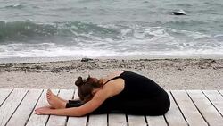 Young woman doing yoga at the seaside Stock Footage