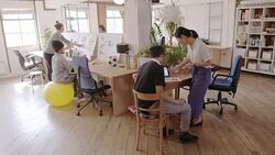 Creative designers working and planning in open plan office Stock Footage