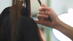 Beautiful girl does a hairstyle in a beauty salon Stock Footage