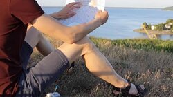A tourist looks at a map in a mountainous area Stock Footage