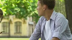 Guy worries, runs up to pretty girl to give bouquet of flowers, first love Stock Footage