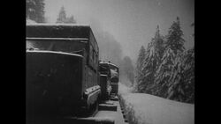 California, 1952: A train's conductor communicates using a phone as a train attempts to pass through heaps of snow Stock Footage