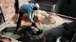Worker mixing cement on construction site. Stock Footage