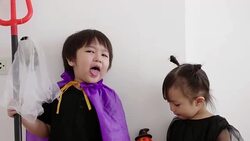 Asian brother and sister with Halloween dress while playing and acting like Ghost with humor and positive emotion Stock Footage