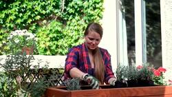 Woman planting on her garden deck. Stock Footage