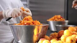 hands pastry chef cutting apricots, prepare the jam in industrial kitchen worktop Stock Footage