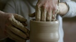 Boy Helping Potter Throwing Vase Stock Footage