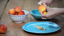 Female hands peeling a blanched peach. Stock Footage