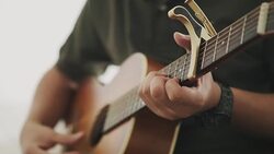Guitarist is playing guitar while using capo Stock Footage