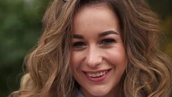 SLOW MOTION: Video portrait of a young woman with brown hair. Close-up of a woman's face. Stock Footage