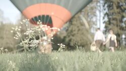 Couple walks with picnic basket to hot air balloon Stock Footage