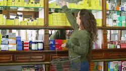 Woman with basket buying beauty products at store Stock Footage