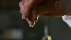 in an Italian professional kitchen a chef pours salt on a dish or in the water to boil the Italian pasta concept of healthy and light food. Stock Footage