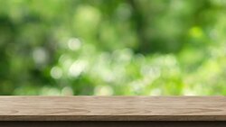 Empty wood table top with blur green tree at park bokeh light background,Backdrop template for display of product or design,food stand mock up Stock Footage