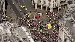 Aerials of police surrounding the pink Extinction Rebellion yacht News Clip