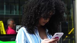 Young Girl Using Mobile Outdoors Stock Footage