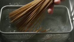 slow motion of Italian pasta typical that falls inside a full pot of boiling water to cook the Italian dough of superior quality. Stock Footage