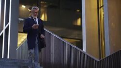 Mature businessman using mobile phone after work Stock Footage