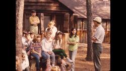 United States, 1930s-1940s: A factory worker uses a power sander to sand the steel exterior of a partially built car Stock Footage