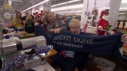 Boris Johnson sewing and holding up a 'Get Brexit Done' scarf News Clip
